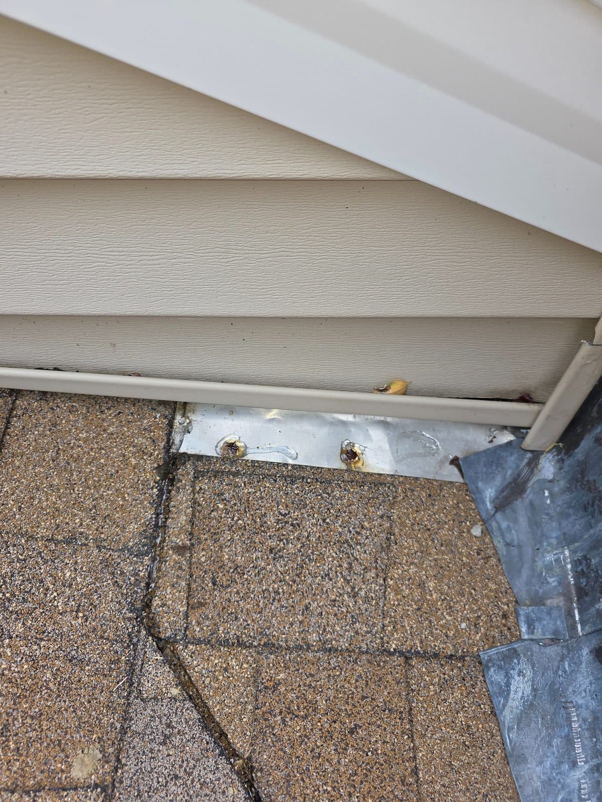 Both exposed nail heads on the apron flashing capped with sealant.