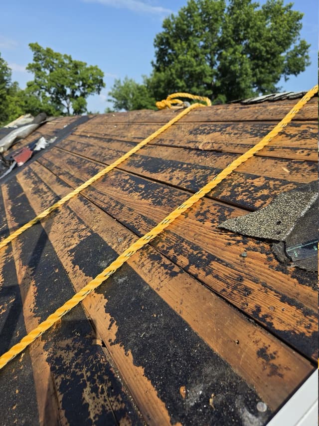 Exposed board roof decking with remnants of old felt
