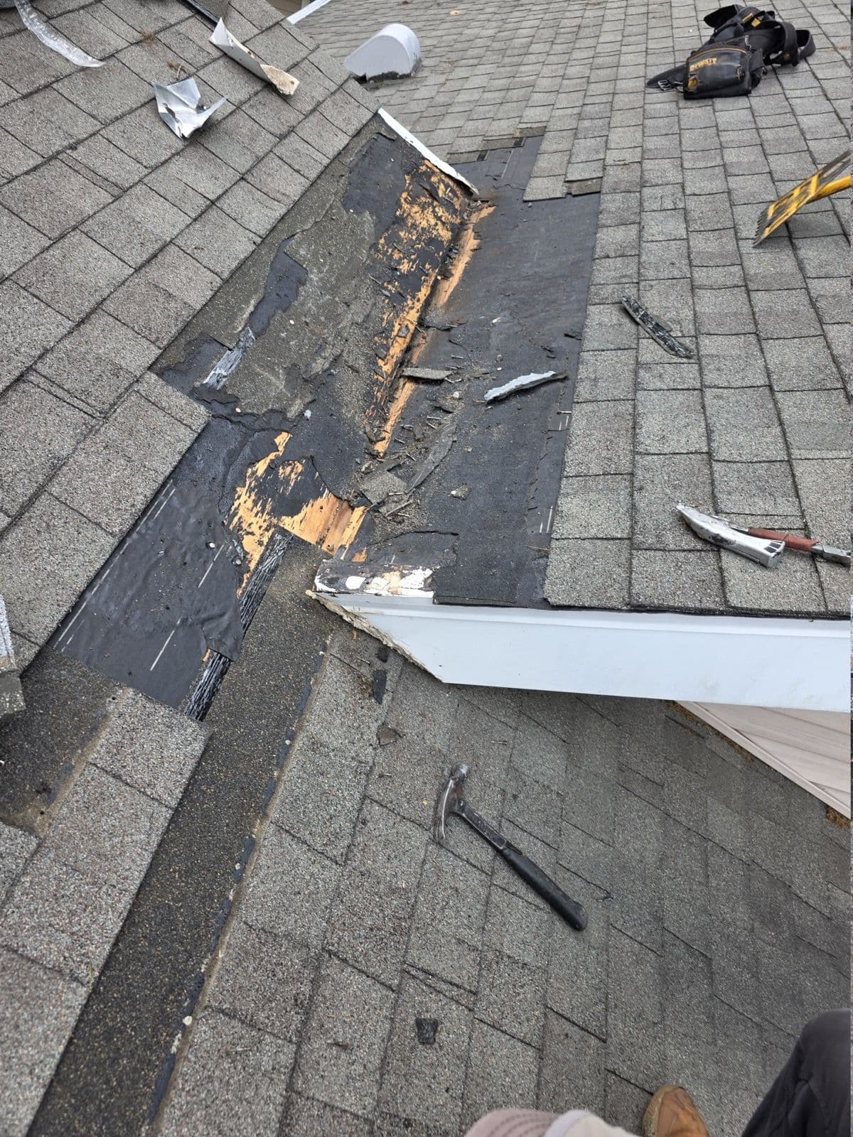 Opened roof-to-wall junction with underlying layers exposed